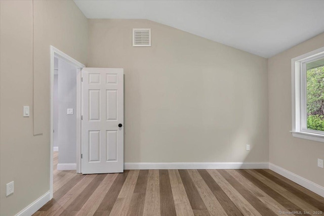 1813 Peck Ln, Cheshire, CT 06410 - empty room with wood finished floors, lofted ceiling, and baseboards