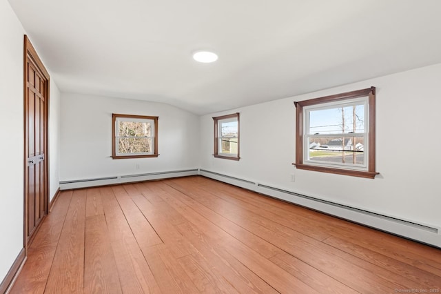 689 S Meriden Rd, Cheshire, CT 06410 - unfurnished bedroom with baseboard heating, light wood-style flooring, lofted ceiling, a closet, and baseboards