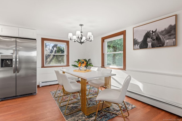 689 S Meriden Rd, Cheshire, CT 06410 - dining space featuring a chandelier, a baseboard radiator, and light wood-style flooring