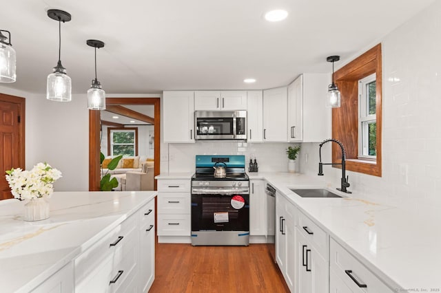 689 S Meriden Rd, Cheshire, CT 06410 - kitchen featuring appliances with stainless steel finishes, a sink, recessed lighting, decorative backsplash, and light wood finished floors