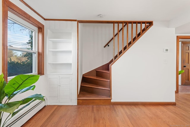 689 S Meriden Rd, Cheshire, CT 06410 - stairs with baseboard heating, built in features, wood finished floors, and baseboards