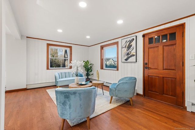 689 S Meriden Rd, Cheshire, CT 06410 - living area with crown molding, a baseboard heating unit, baseboards, wood finished floors, and recessed lighting