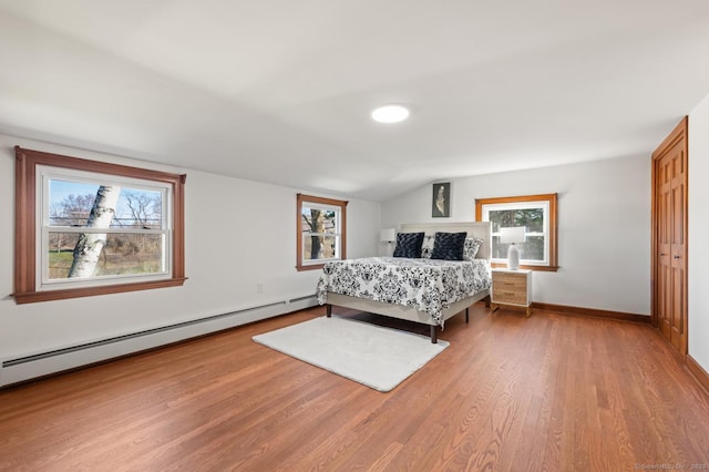 689 S Meriden Rd, Cheshire, CT 06410 - bedroom featuring a baseboard heating unit, wood finished floors, baseboards, and vaulted ceiling