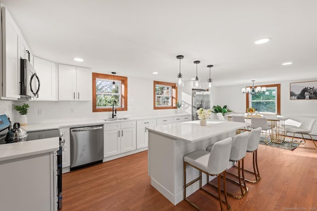 689 S Meriden Rd, Cheshire, CT 06410 - kitchen with appliances with stainless steel finishes, a sink, light wood-type flooring, plenty of natural light, and recessed lighting