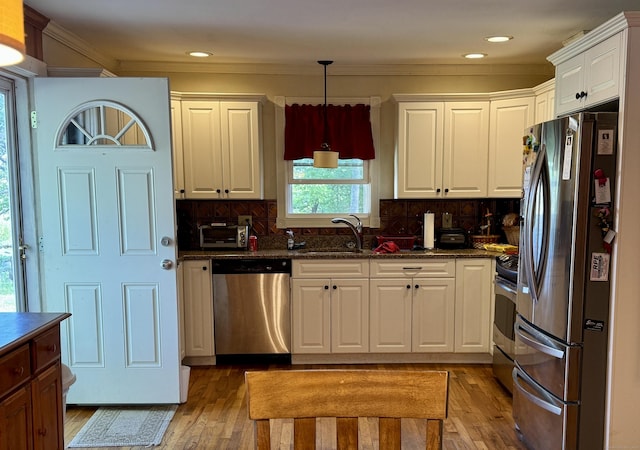 492 Providence New London Tpke, North Stonington, CT 06359 - kitchen featuring stainless steel appliances, light wood-type flooring, white cabinets, a sink, and ornamental molding