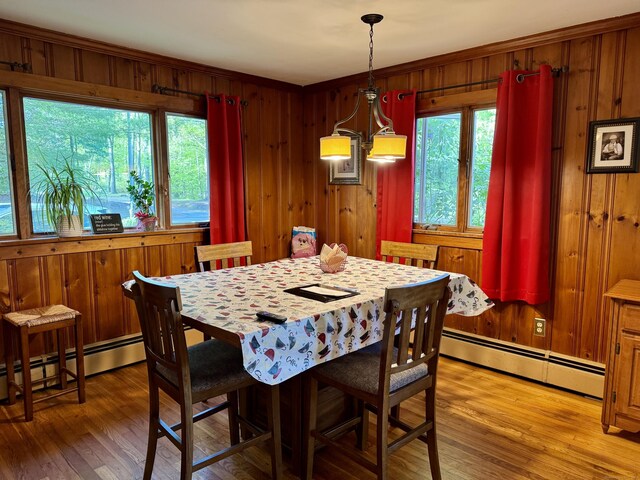 492 Providence New London Tpke, North Stonington, CT 06359 - dining area with a baseboard radiator, light wood-style flooring, wooden walls, and a chandelier