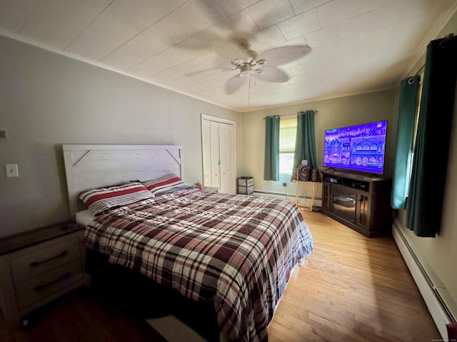 492 Providence New London Tpke, North Stonington, CT 06359 - bedroom featuring a baseboard heating unit, wood finished floors, ceiling fan, and a closet