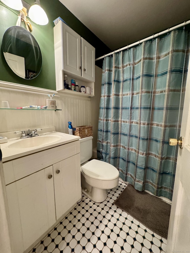 492 Providence New London Tpke, North Stonington, CT 06359 - full bathroom featuring vanity, toilet, a wainscoted wall, and a shower with shower curtain