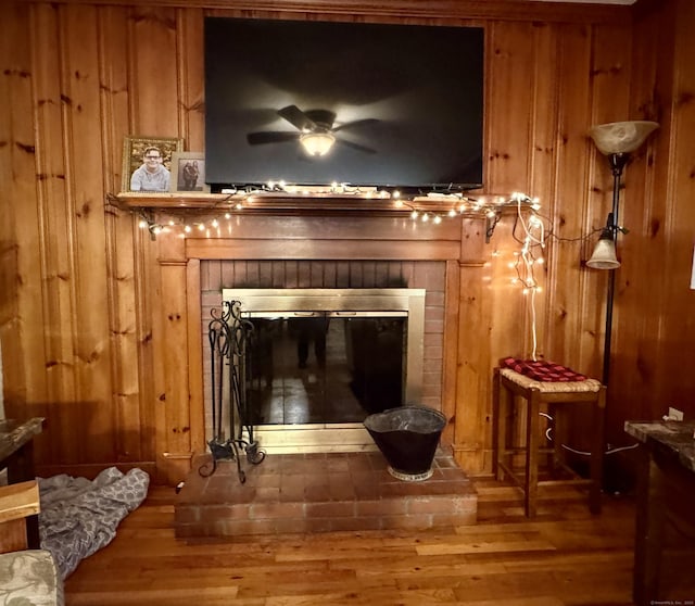 492 Providence New London Tpke, North Stonington, CT 06359 - detailed view of a ceiling fan, wooden walls, a fireplace, and wood finished floors