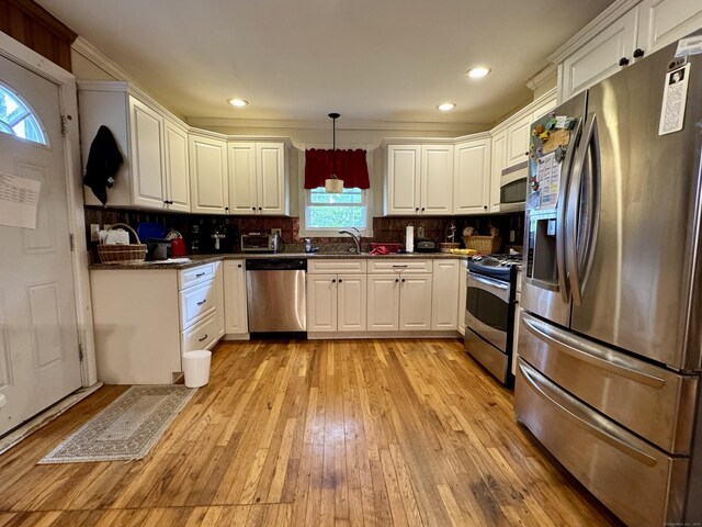 492 Providence New London Tpke, North Stonington, CT 06359 - kitchen with appliances with stainless steel finishes, a sink, light wood finished floors, white cabinetry, and recessed lighting
