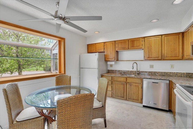 547 Pilgrim Hbr Unit 547, Wallingford, CT 06492 - kitchen with white appliances, a sink, a ceiling fan, a textured ceiling, and brown cabinetry