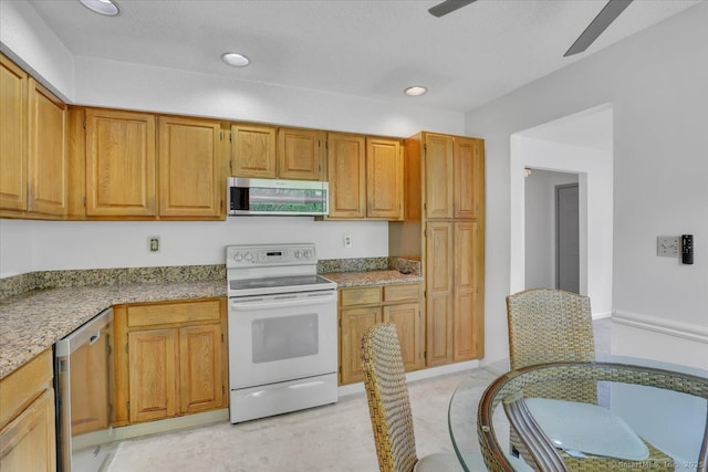 547 Pilgrim Hbr Unit 547, Wallingford, CT 06492 - kitchen featuring stainless steel appliances, ceiling fan, recessed lighting, brown cabinetry, and light stone counters