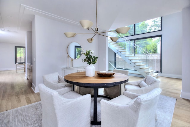 158 Compo Rd N, Westport, CT 06880 - dining space featuring light wood finished floors, stairway, baseboards, a chandelier, and attic access