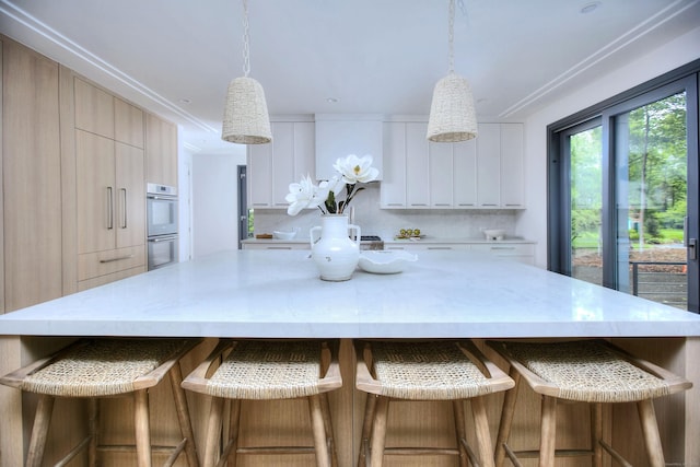 158 Compo Rd N, Westport, CT 06880 - kitchen featuring modern cabinets, white double oven, light countertops, a spacious island, and hanging light fixtures