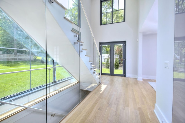 158 Compo Rd N, Westport, CT 06880 - foyer with plenty of natural light, wood finished floors, a high ceiling, stairway, and baseboards