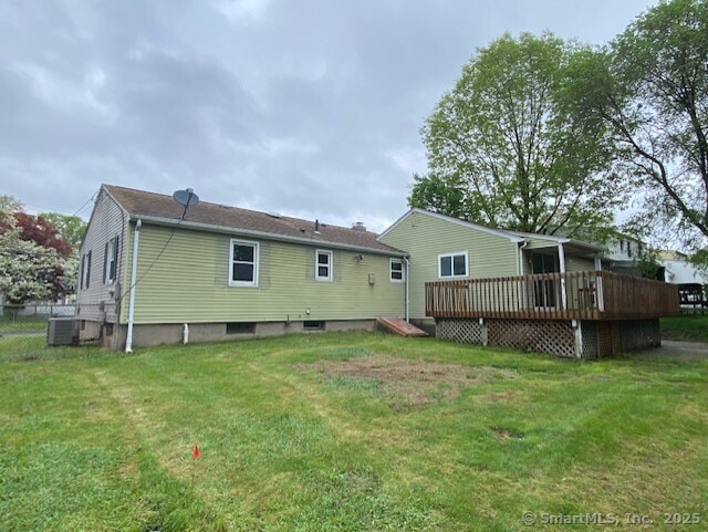 147 Chester St, East Hartford, CT 06108 - rear view of house featuring a wooden deck, a lawn, and central AC unit