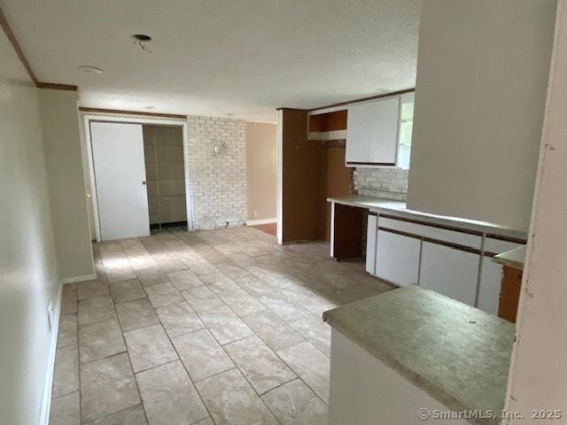 147 Chester St, East Hartford, CT 06108 - kitchen with white cabinetry and baseboards