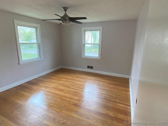 147 Chester St, East Hartford, CT 06108 - spare room featuring plenty of natural light, light wood-type flooring, and baseboards