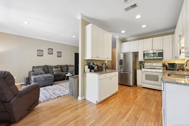 20 Goodwin Cir Unit 20, Hartford, CT 06105 - kitchen with appliances with stainless steel finishes, open floor plan, ornamental molding, light wood-style flooring, and white cabinets