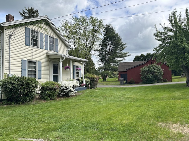 2060 Perkins St, Bristol, CT 06010 - view of front of home featuring a front yard and a chimney