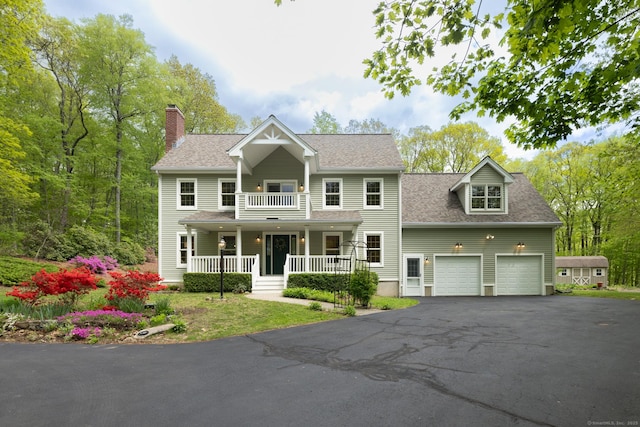 67 Blue Heron Dr, East Hampton, CT 06424 - view of front facade with covered porch, driveway, a chimney, and a shingled roof