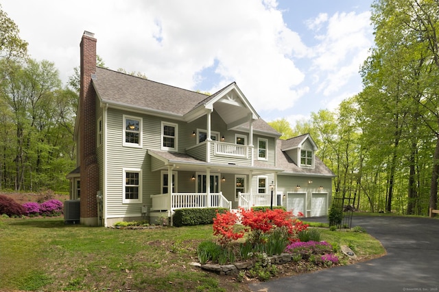 67 Blue Heron Dr, East Hampton, CT 06424 - view of front of house with covered porch, a chimney, a balcony, asphalt driveway, and central AC