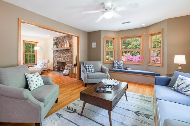 67 Blue Heron Dr, East Hampton, CT 06424 - living area with healthy amount of natural light, wood finished floors, a fireplace, and a ceiling fan