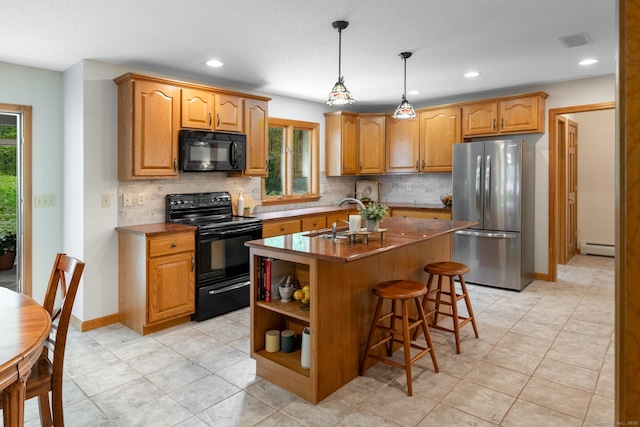 67 Blue Heron Dr, East Hampton, CT 06424 - kitchen with black appliances, a sink, tasteful backsplash, a baseboard heating unit, and recessed lighting