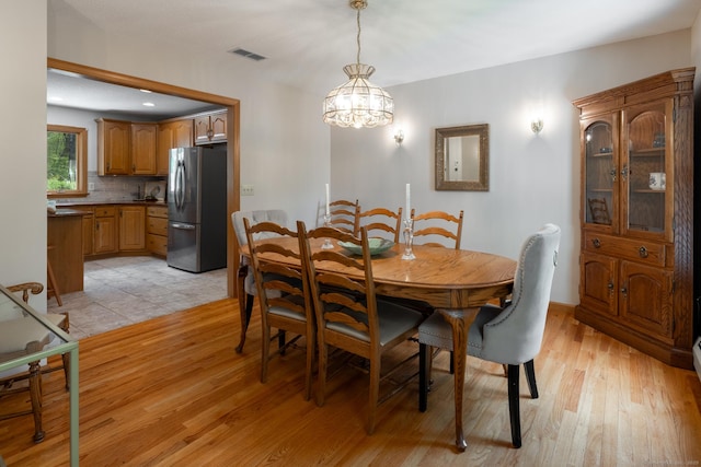 67 Blue Heron Dr, East Hampton, CT 06424 - dining room featuring light wood-type flooring and a chandelier