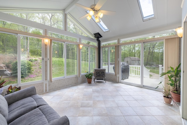 67 Blue Heron Dr, East Hampton, CT 06424 - sunroom with a skylight, a wood stove, plenty of natural light, vaulted ceiling, and tile patterned floors