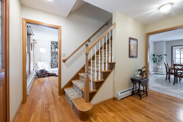 67 Blue Heron Dr, East Hampton, CT 06424 - stairs featuring baseboard heating, wood finished floors, a baseboard heating unit, and baseboards