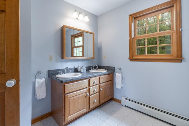 67 Blue Heron Dr, East Hampton, CT 06424 - full bath featuring baseboard heating, baseboards, double vanity, and tile patterned flooring