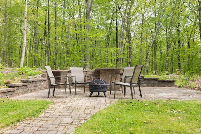 67 Blue Heron Dr, East Hampton, CT 06424 - view of patio featuring an outdoor fire pit and a view of trees