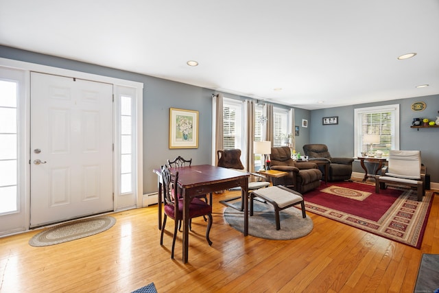 living area with light wood finished floors, recessed lighting, and baseboard heating