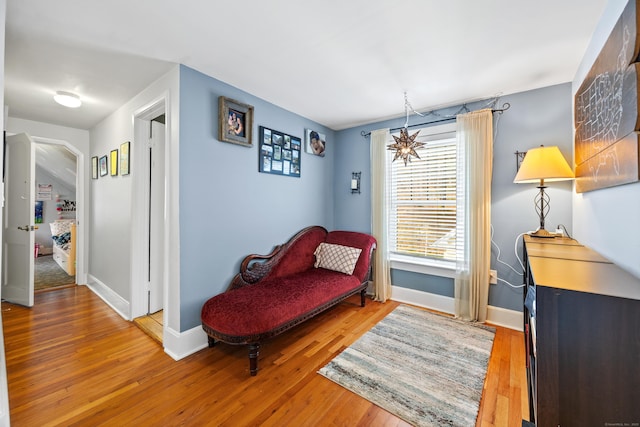 sitting room with hardwood / wood-style flooring and baseboards