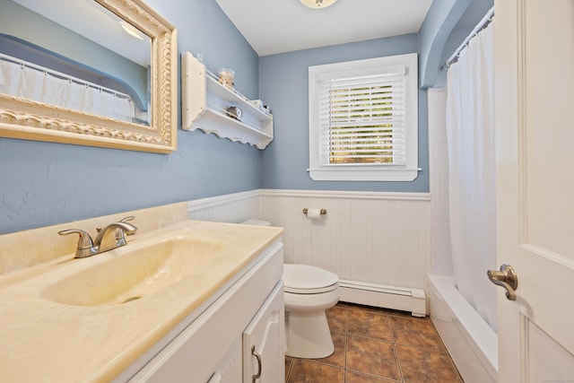 bathroom with baseboard heating, toilet, wainscoting, and vanity