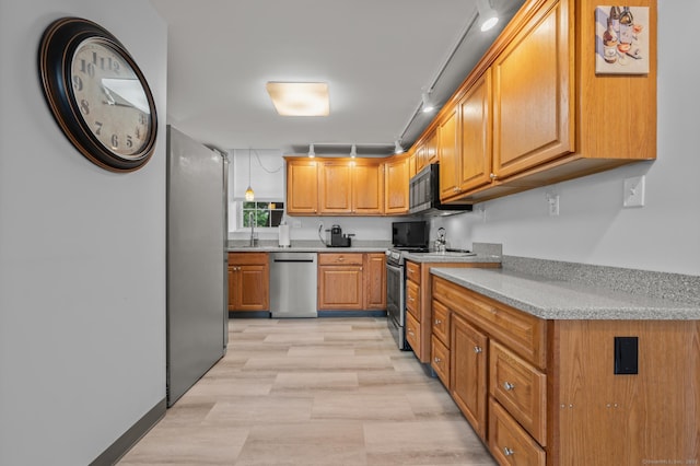 8 Pasco Dr Unit E, East Windsor, CT 06088 - kitchen with stainless steel appliances, light countertops, brown cabinetry, and a sink