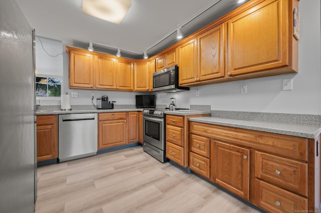 8 Pasco Dr Unit E, East Windsor, CT 06088 - kitchen with appliances with stainless steel finishes, light wood-type flooring, track lighting, and light countertops