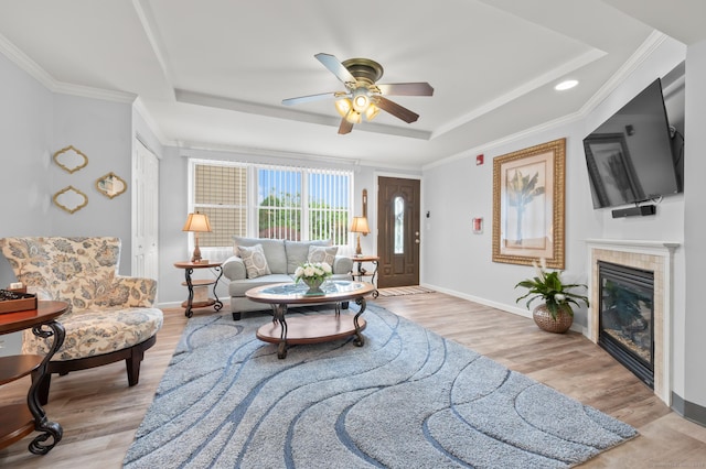 8 Pasco Dr Unit E, East Windsor, CT 06088 - living room with a tray ceiling, a ceiling fan, wood finished floors, baseboards, and crown molding