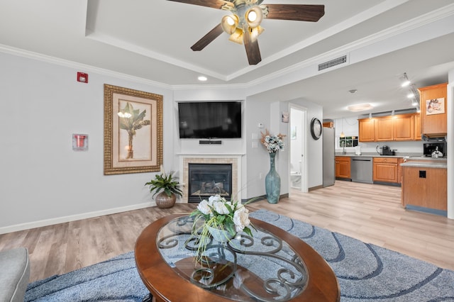 8 Pasco Dr Unit E, East Windsor, CT 06088 - living area featuring ceiling fan, light wood-type flooring, baseboards, a fireplace, and a tray ceiling