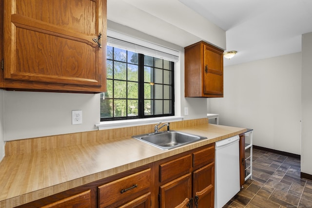 442 Swanson Cres Unit 442, Milford, CT 06461 - kitchen with white dishwasher, a sink, stone finish flooring, and brown cabinets