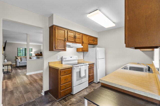 442 Swanson Cres Unit 442, Milford, CT 06461 - kitchen with white appliances, under cabinet range hood, a sink, light countertops, and brown cabinets