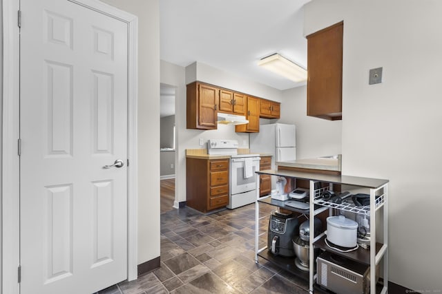 442 Swanson Cres Unit 442, Milford, CT 06461 - kitchen with white appliances, under cabinet range hood, brown cabinets, baseboards, and light countertops