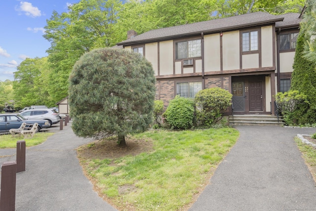 442 Swanson Cres Unit 442, Milford, CT 06461 - view of front of property featuring a shingled roof, stucco siding, a chimney, and brick siding