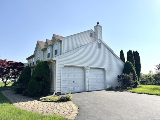 26 John George Dr, Meriden, CT 06450 - view of property exterior with driveway, a garage, and a chimney