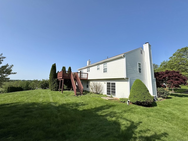 26 John George Dr, Meriden, CT 06450 - rear view of property with a chimney, stairway, a wooden deck, and a lawn
