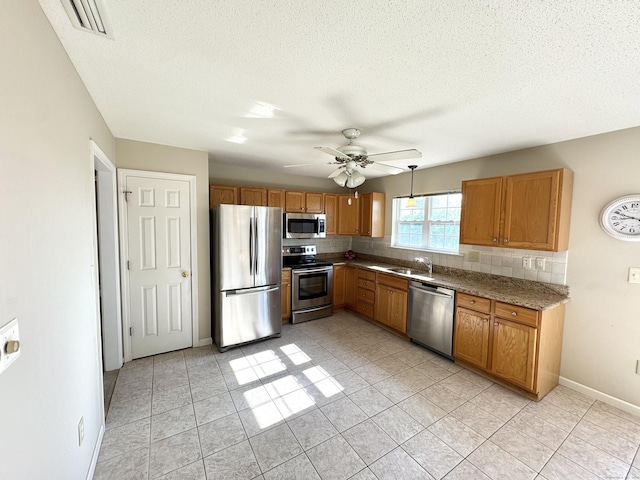 26 John George Dr, Meriden, CT 06450 - kitchen with appliances with stainless steel finishes, backsplash, a ceiling fan, light tile patterned flooring, and a textured ceiling