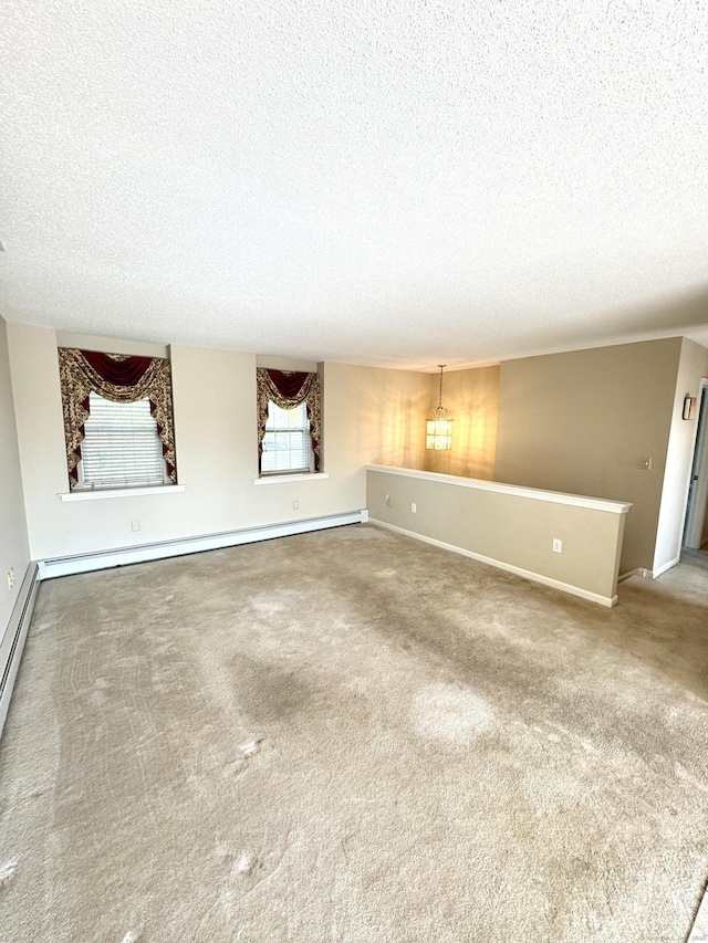 26 John George Dr, Meriden, CT 06450 - unfurnished living room featuring a textured ceiling, carpet, baseboards, and a baseboard radiator