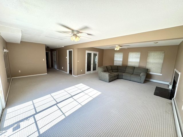 26 John George Dr, Meriden, CT 06450 - unfurnished living room with a baseboard radiator, carpet flooring, baseboards, a ceiling fan, and a textured ceiling