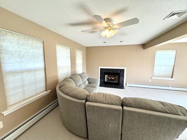 26 John George Dr, Meriden, CT 06450 - carpeted living area featuring a baseboard heating unit, a ceiling fan, baseboards, a textured ceiling, and a tiled fireplace